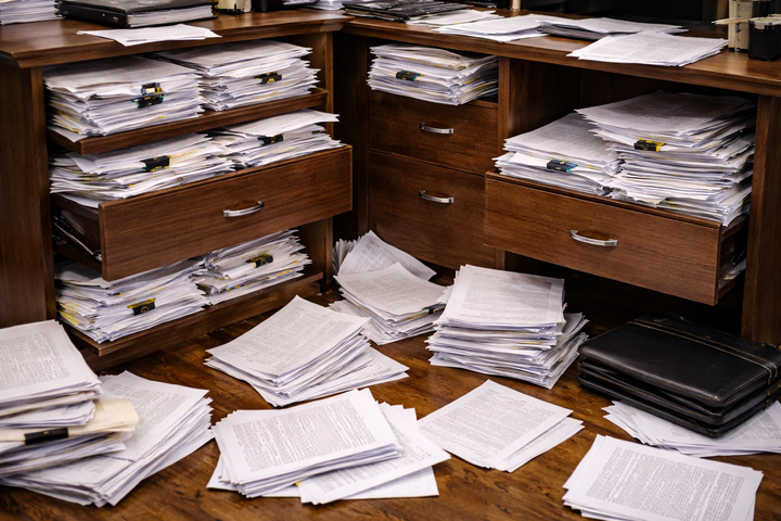 Contracts overflowing drawers and cabinets.